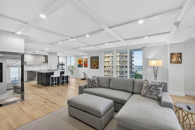 a living room with furniture and a floor to ceiling window
