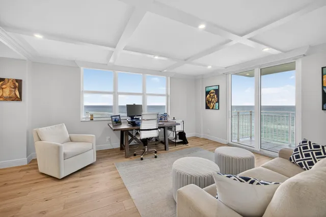 a view of a livingroom with workspace and a couch