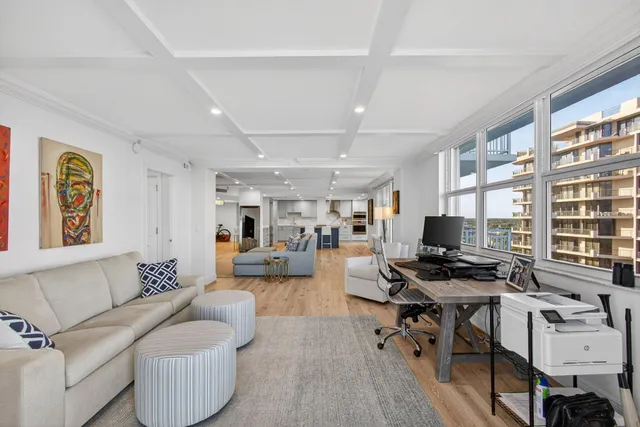 a kitchen with stainless steel appliances kitchen island granite countertop a table chairs sink refrigerator and cabinets