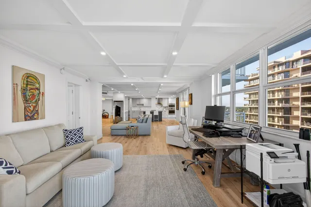 a kitchen with stainless steel appliances kitchen island granite countertop a table chairs sink refrigerator and cabinets