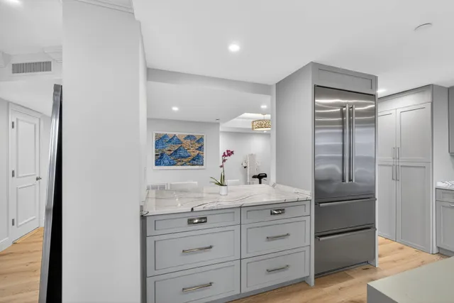 a kitchen with stainless steel appliances granite countertop a lot of counter space and windows