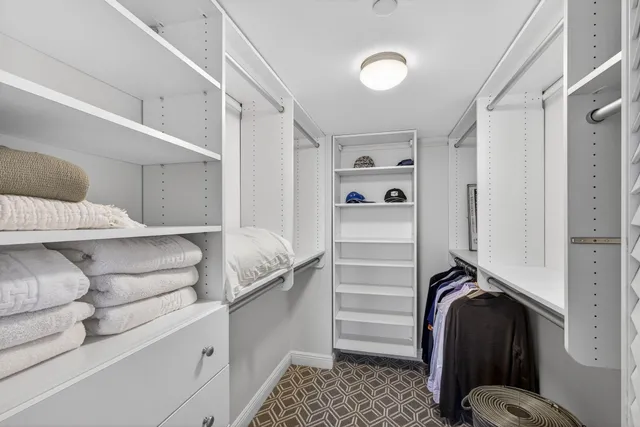a bathroom with a granite countertop sink mirror and toilet