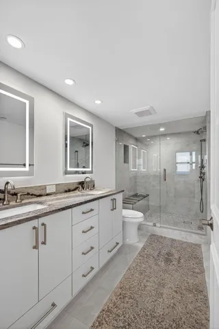 a front view of a house with a garden and plants