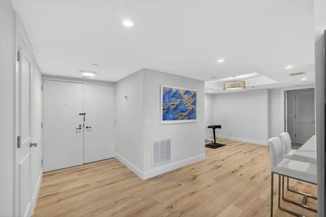 a view of a room with wooden floor and window