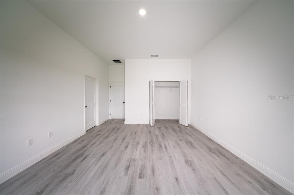 4705 Southwest 159th Lane Ocala, FL 34473 - Photo 14 of 18 a view of an empty room and wooden floor