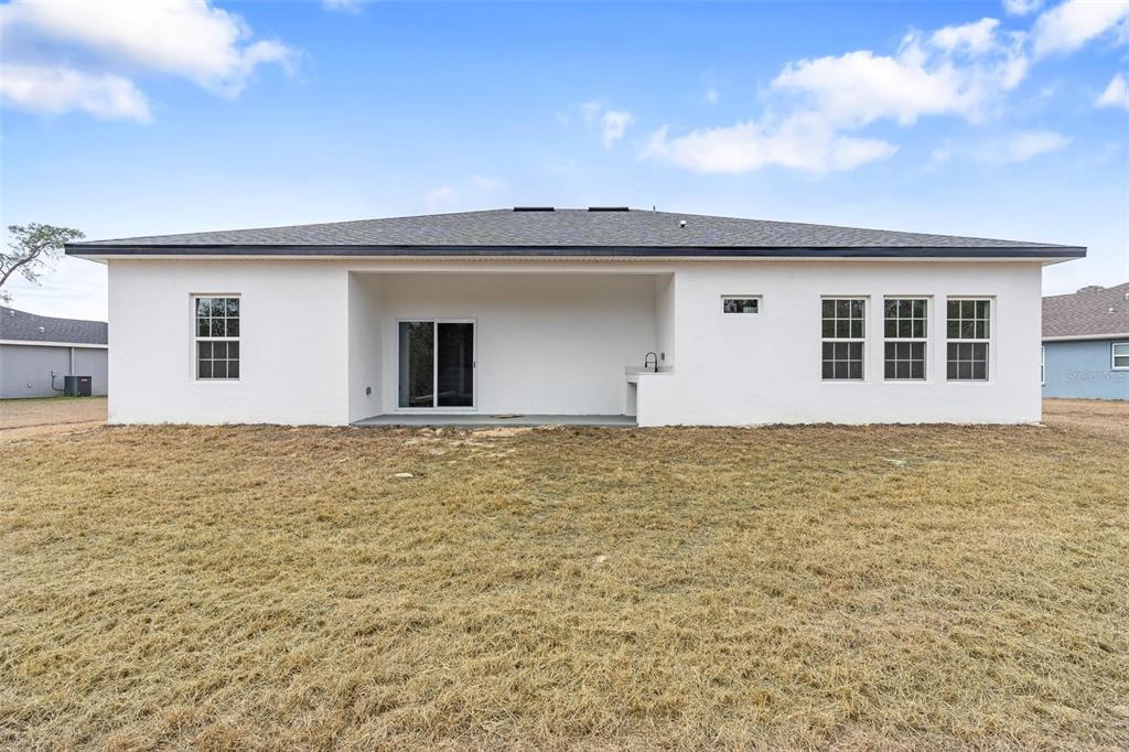 4705 Southwest 159th Lane Ocala, FL 34473 - Photo 26 of 28 a front view of a house with an outdoor space