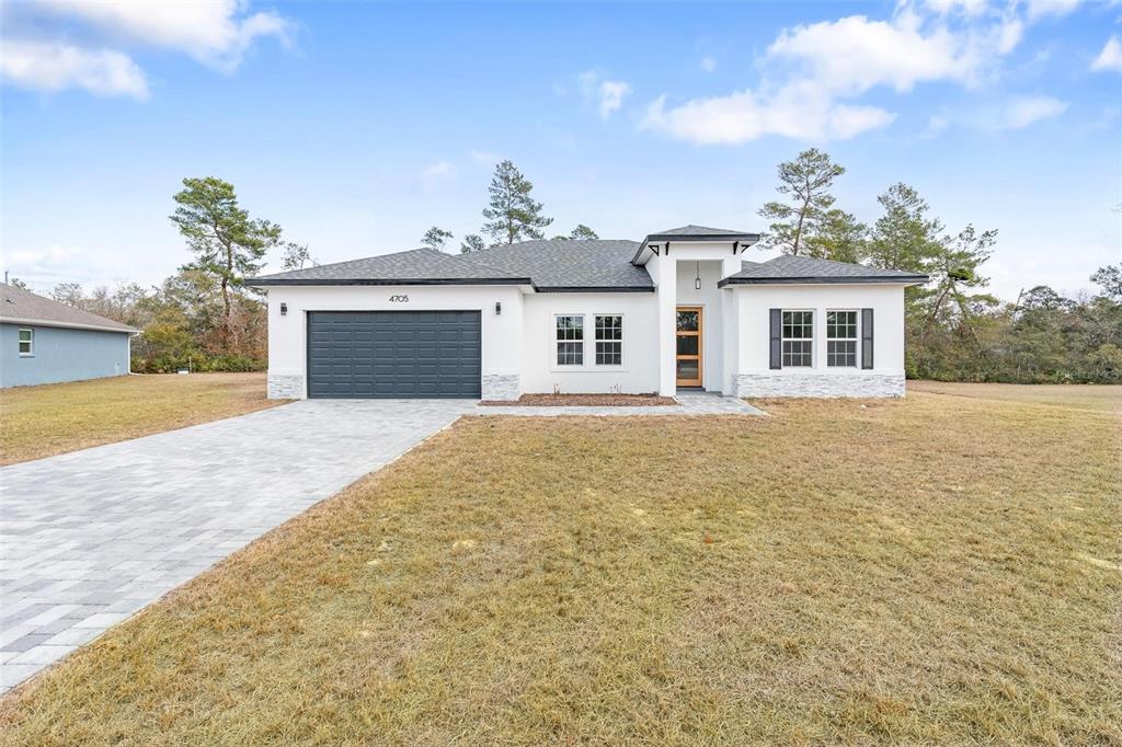 4705 Southwest 159th Lane Ocala, FL 34473 - Photo 3 of 28 front view of a house with a yard