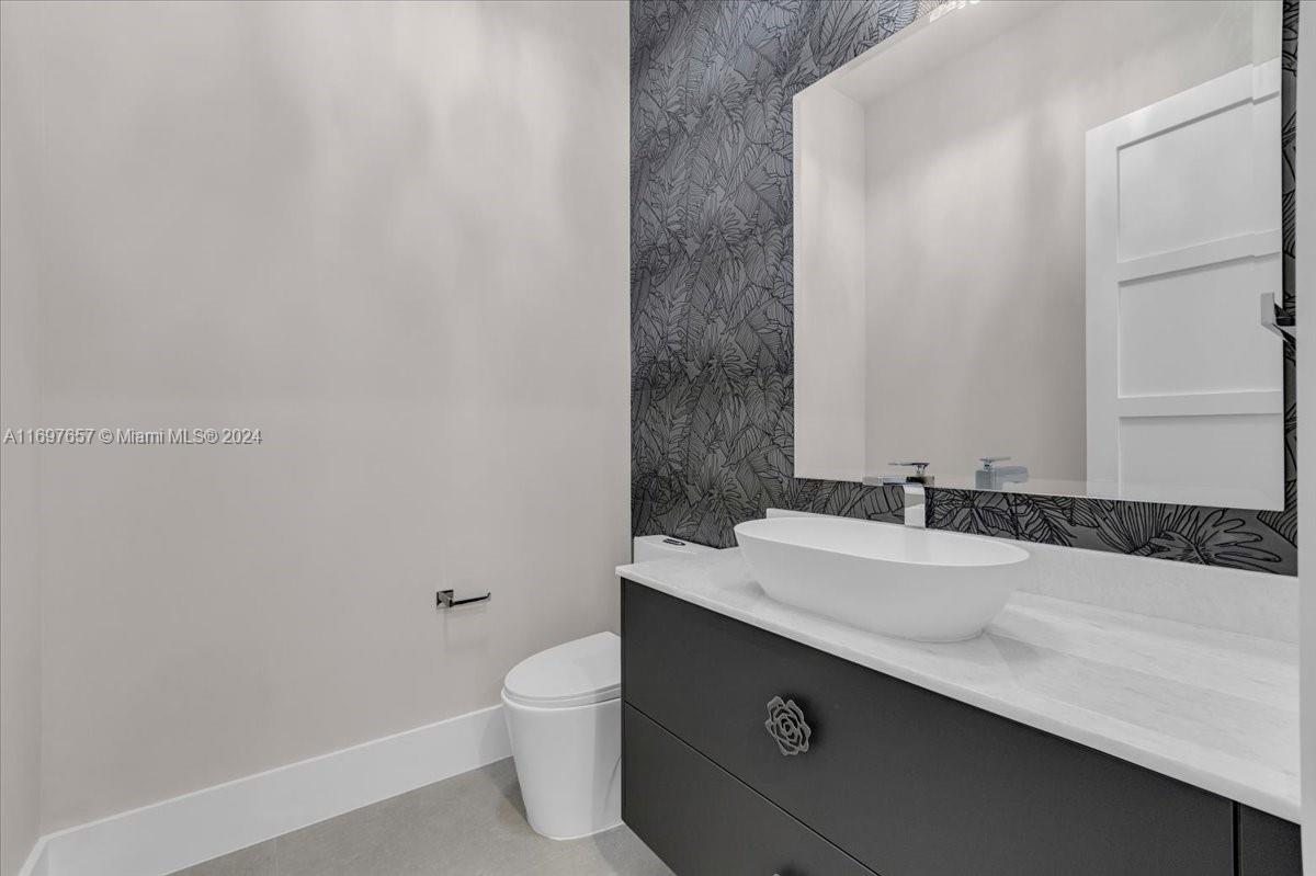 751 Northeast 2nd Street Boca Raton, FL 33432 - Photo 12 of 56 a bathroom with a sink and a toilet