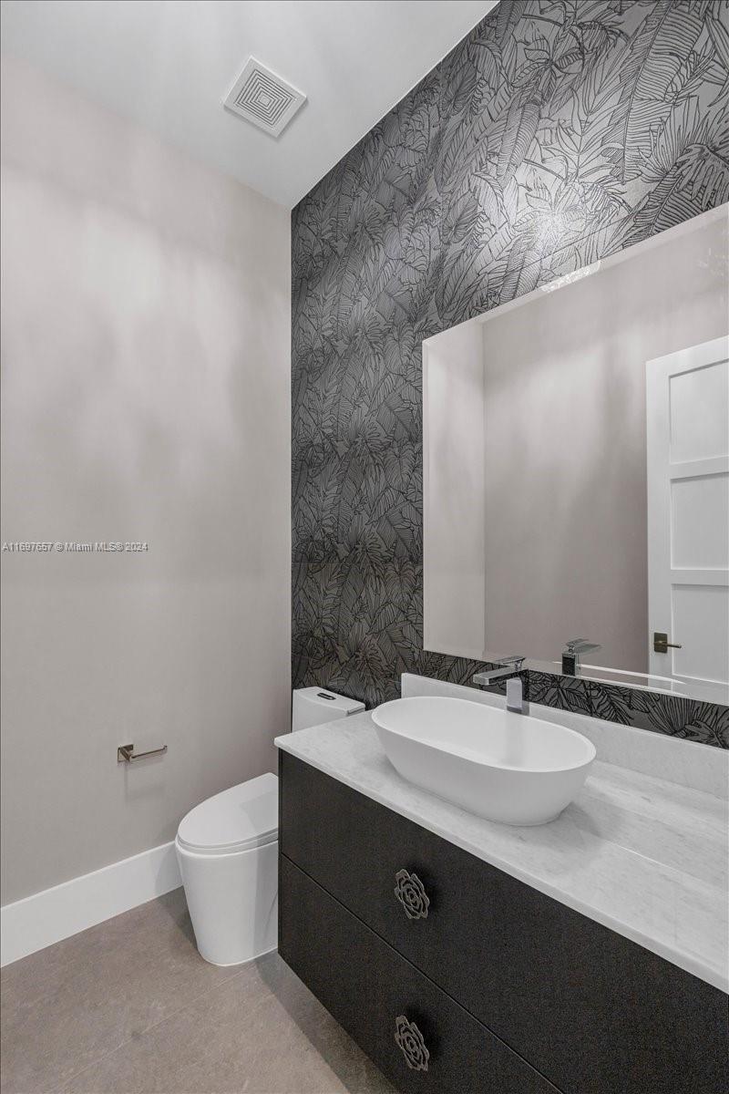 751 Northeast 2nd Street Boca Raton, FL 33432 - Photo 13 of 56 a bathroom with a sink and a mirror