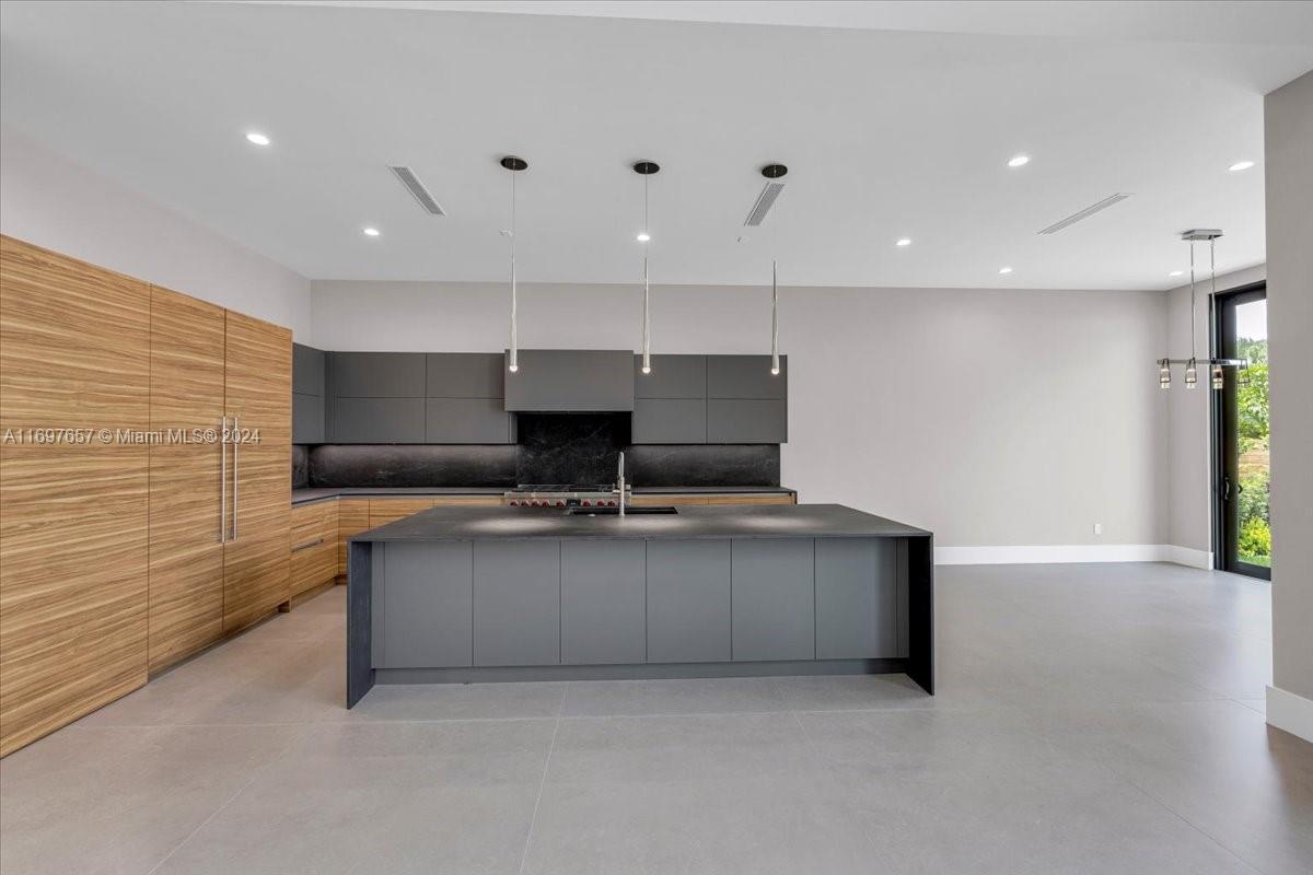 751 Northeast 2nd Street Boca Raton, FL 33432 - Photo 17 of 56 a open kitchen with stainless steel appliances granite countertop a sink and a stove