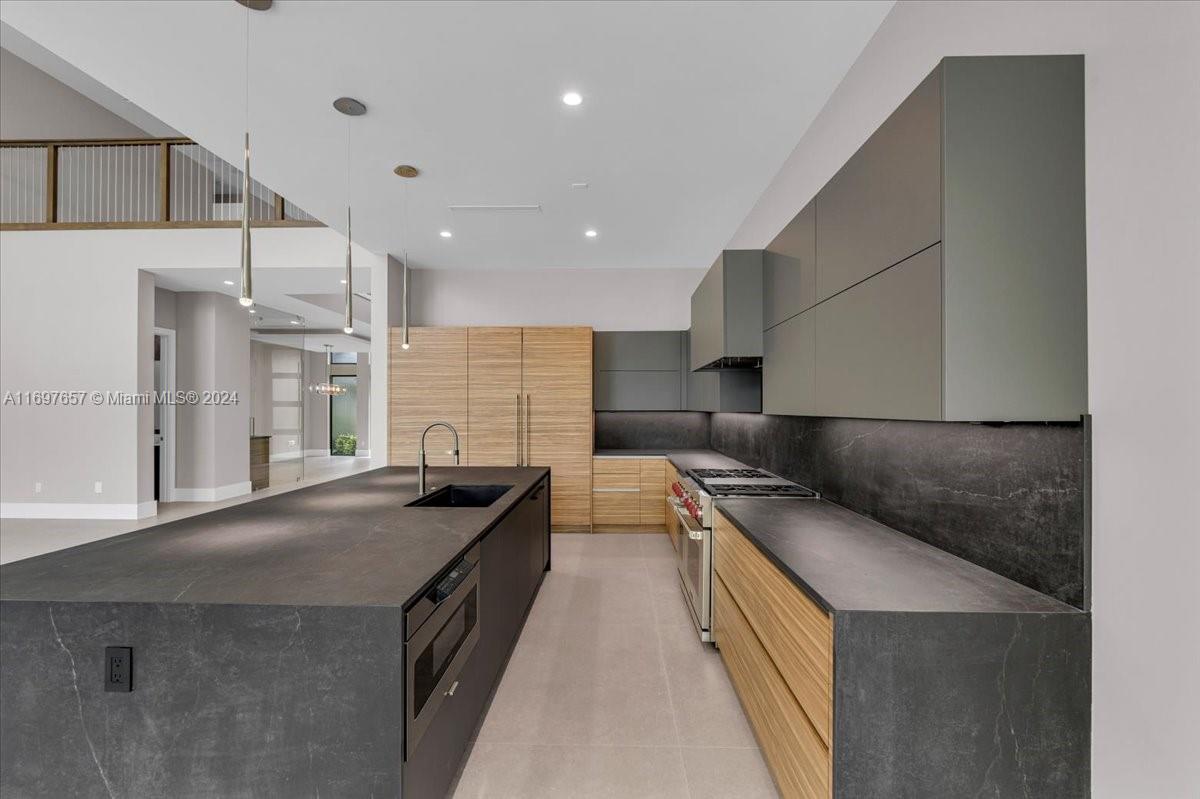751 Northeast 2nd Street Boca Raton, FL 33432 - Photo 18 of 56 a kitchen with stainless steel appliances granite countertop a sink and cabinets