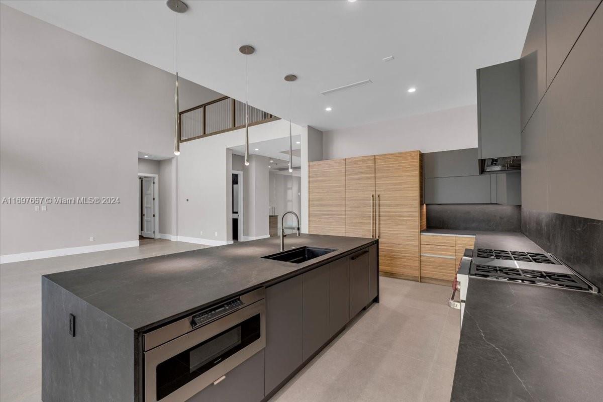 751 Northeast 2nd Street Boca Raton, FL 33432 - Photo 19 of 56 a kitchen that has a sink and a stove