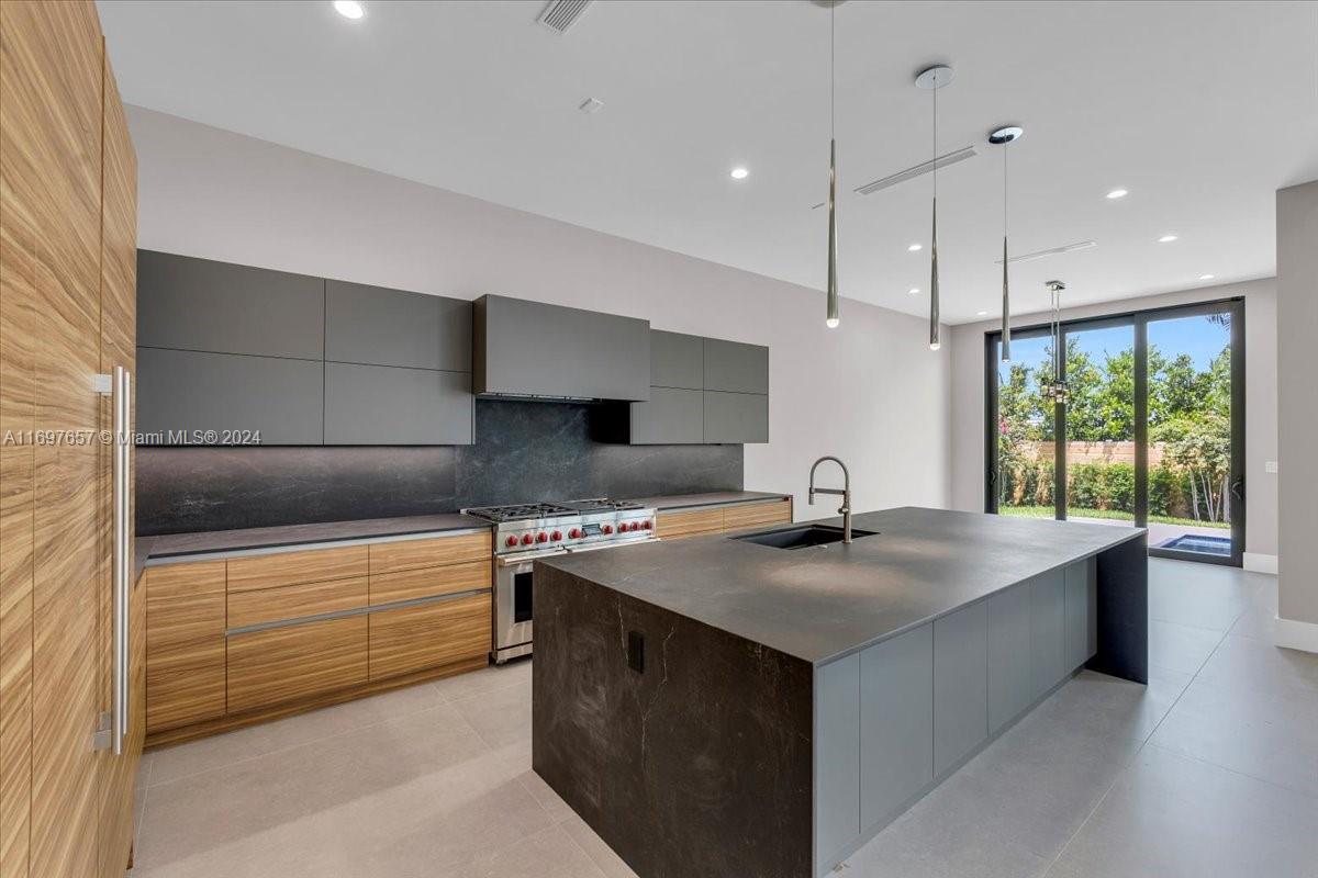751 Northeast 2nd Street Boca Raton, FL 33432 - Photo 20 of 56 a kitchen with stainless steel appliances granite countertop a sink and a stove
