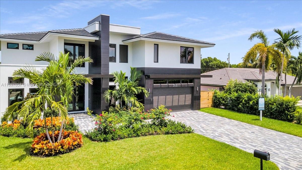 751 Northeast 2nd Street Boca Raton, FL 33432 - Photo 2 of 56 a front view of a house with a yard