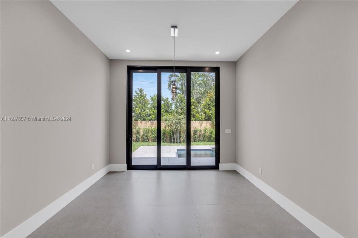 751 Northeast 2nd Street Boca Raton, FL 33432 - Photo 21 of 56 an empty room with windows and outdoor view