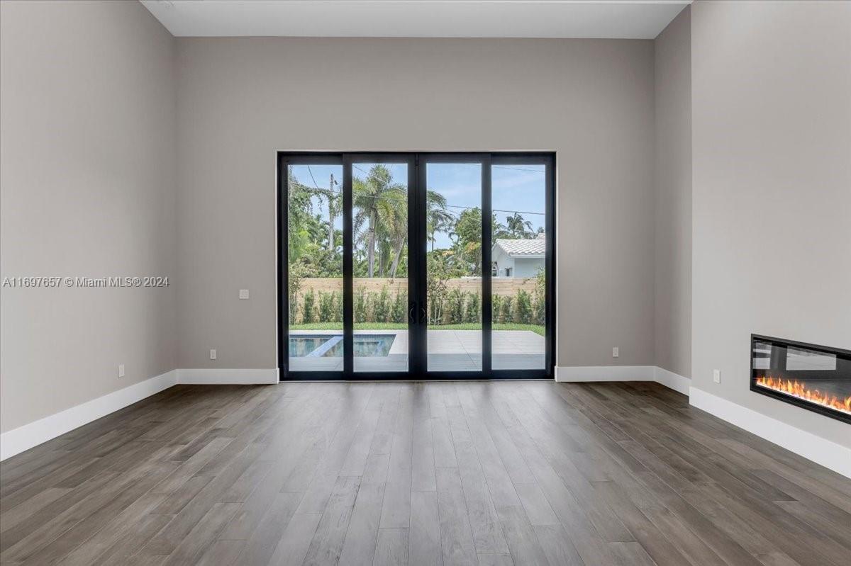 751 Northeast 2nd Street Boca Raton, FL 33432 - Photo 27 of 56 a view of an empty room with wooden floor and a window