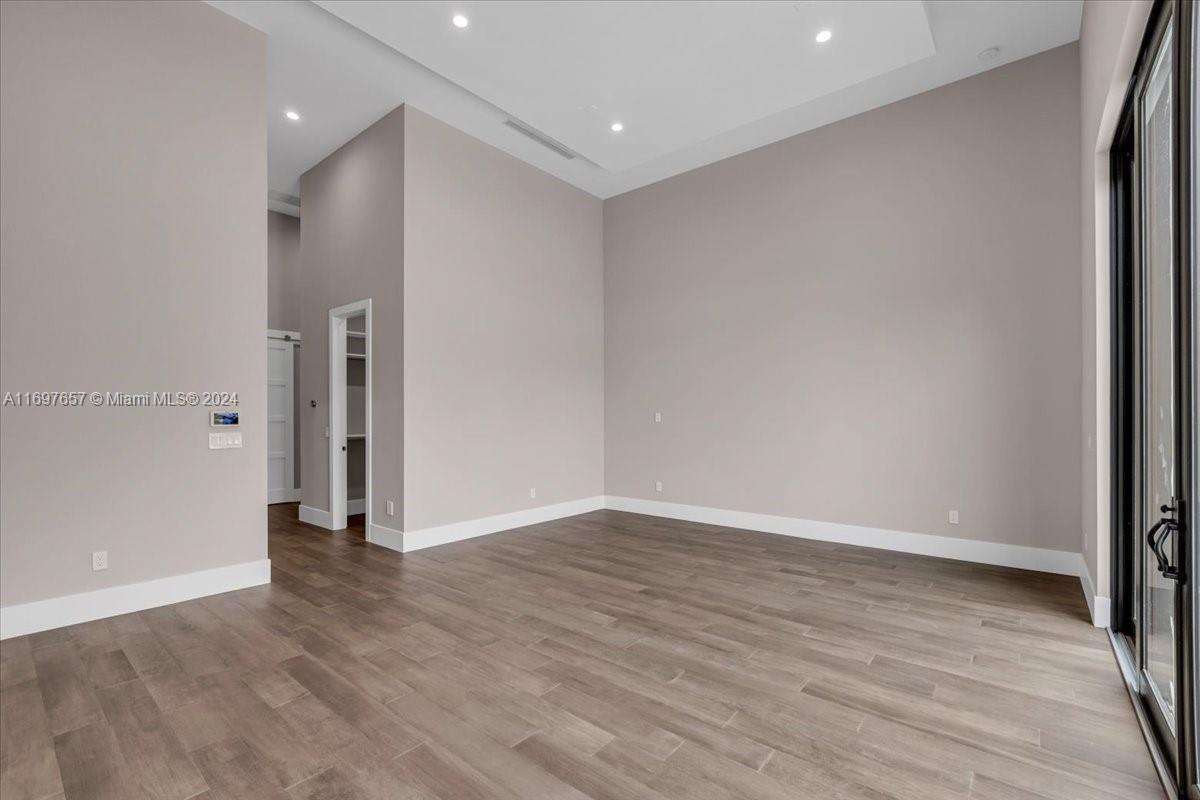 751 Northeast 2nd Street Boca Raton, FL 33432 - Photo 29 of 56 a view of an empty room with wooden floor and a window