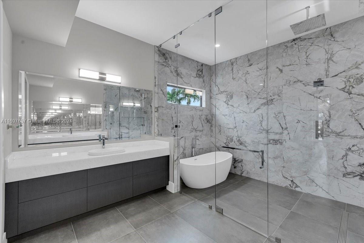 751 Northeast 2nd Street Boca Raton, FL 33432 - Photo 31 of 56 a spacious bathroom with a toilet sink and mirror