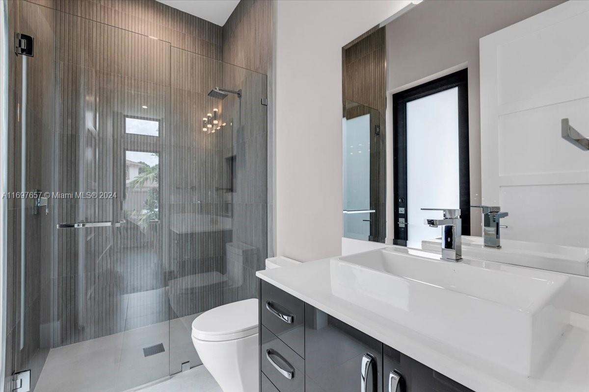 751 Northeast 2nd Street Boca Raton, FL 33432 - Photo 35 of 56 a bathroom with a sink a toilet and shower