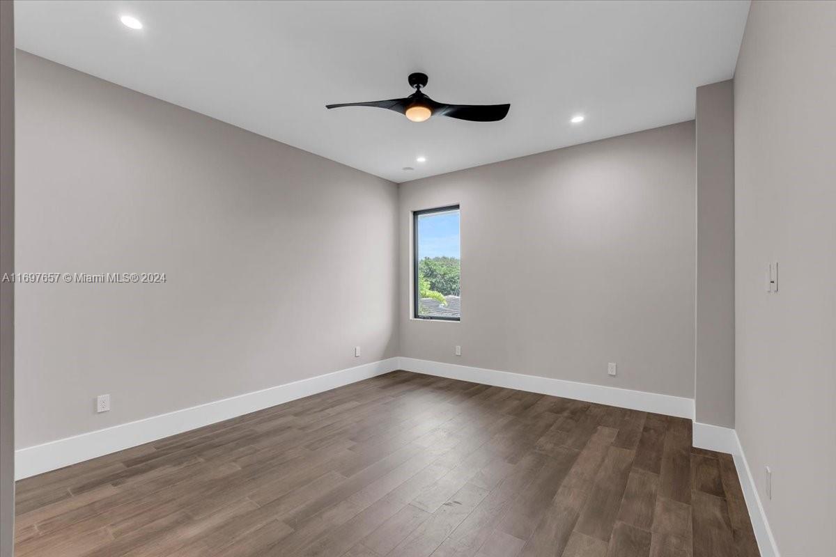 751 Northeast 2nd Street Boca Raton, FL 33432 - Photo 38 of 56 a view of empty room with wooden floor and fan