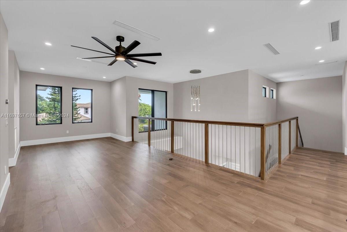 751 Northeast 2nd Street Boca Raton, FL 33432 - Photo 41 of 56 a view of a livingroom with wooden floor and a ceiling fan