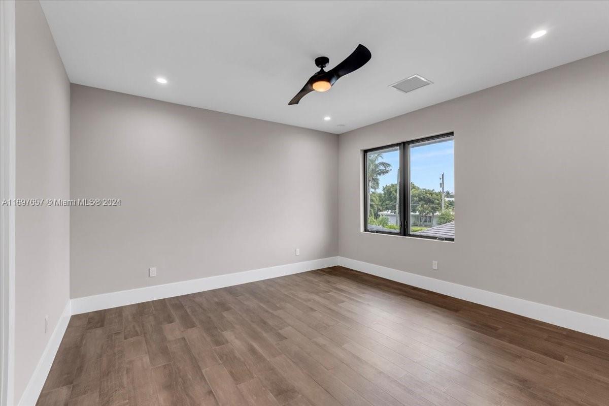 751 Northeast 2nd Street Boca Raton, FL 33432 - Photo 43 of 56 wooden floor in an empty room with a window