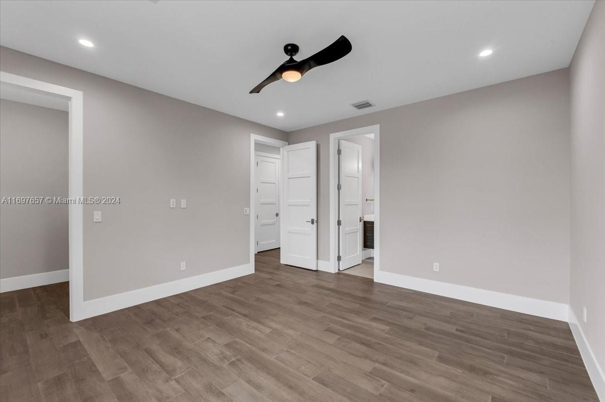 751 Northeast 2nd Street Boca Raton, FL 33432 - Photo 44 of 56 a view of an empty room with wooden floor and a ceiling fan