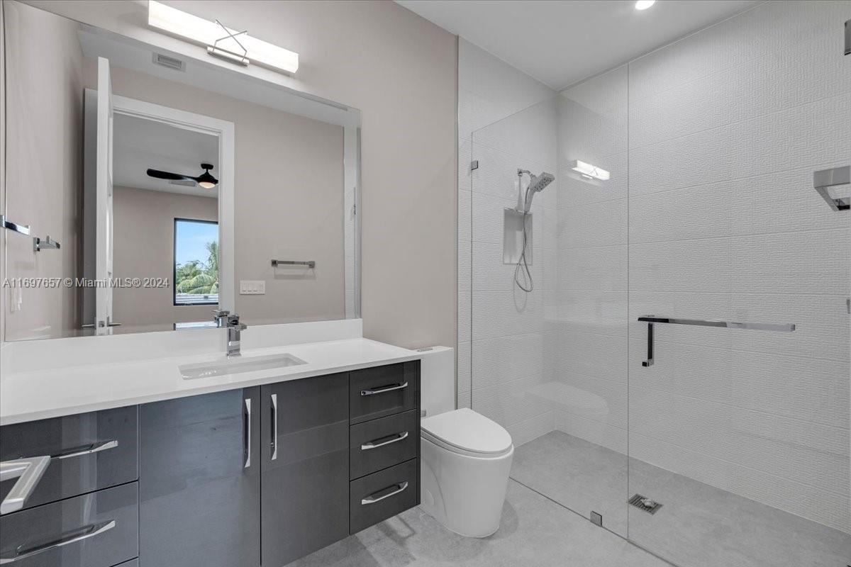 751 Northeast 2nd Street Boca Raton, FL 33432 - Photo 45 of 56 a bathroom with a sink a toilet and shower