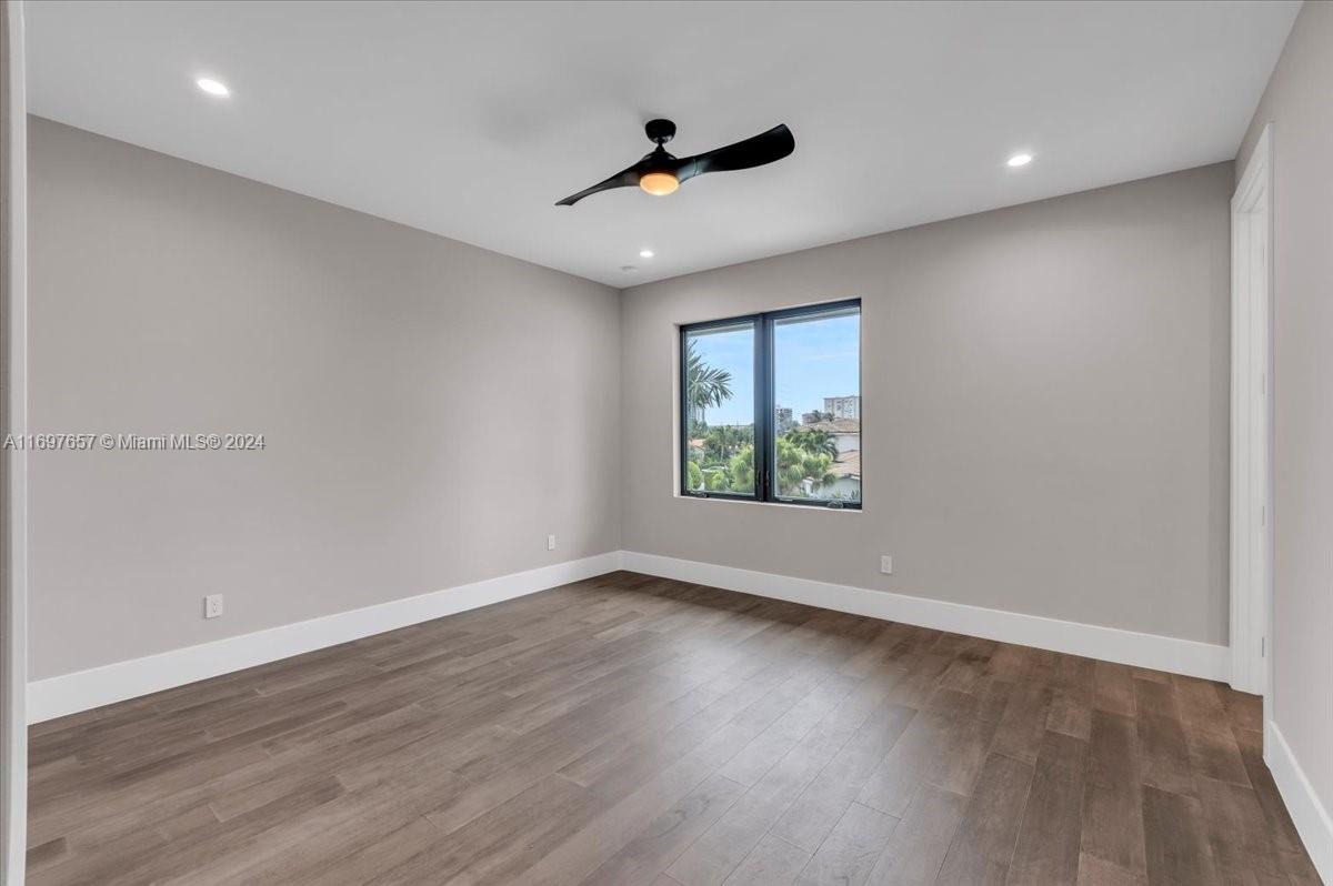 751 Northeast 2nd Street Boca Raton, FL 33432 - Photo 46 of 56 a view of an empty room with wooden floor and a window