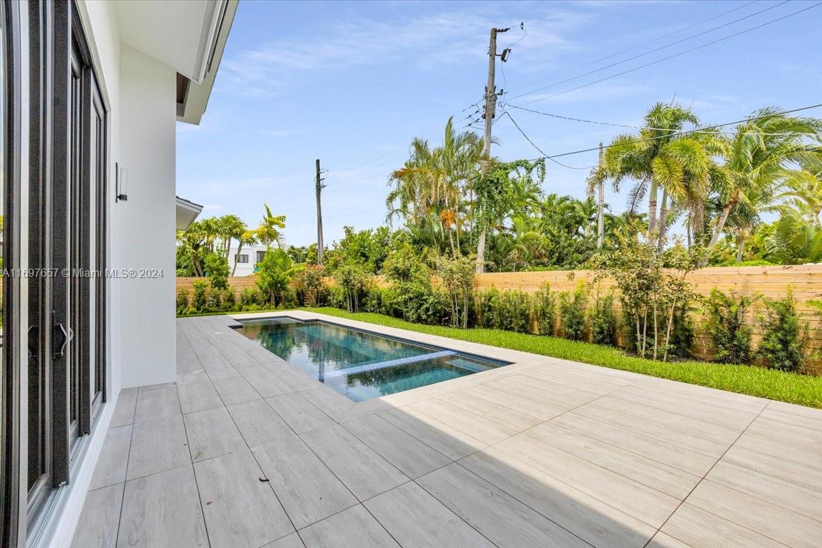 751 Northeast 2nd Street Boca Raton, FL 33432 - Photo 52 of 56 a view of a swimming pool with a yard