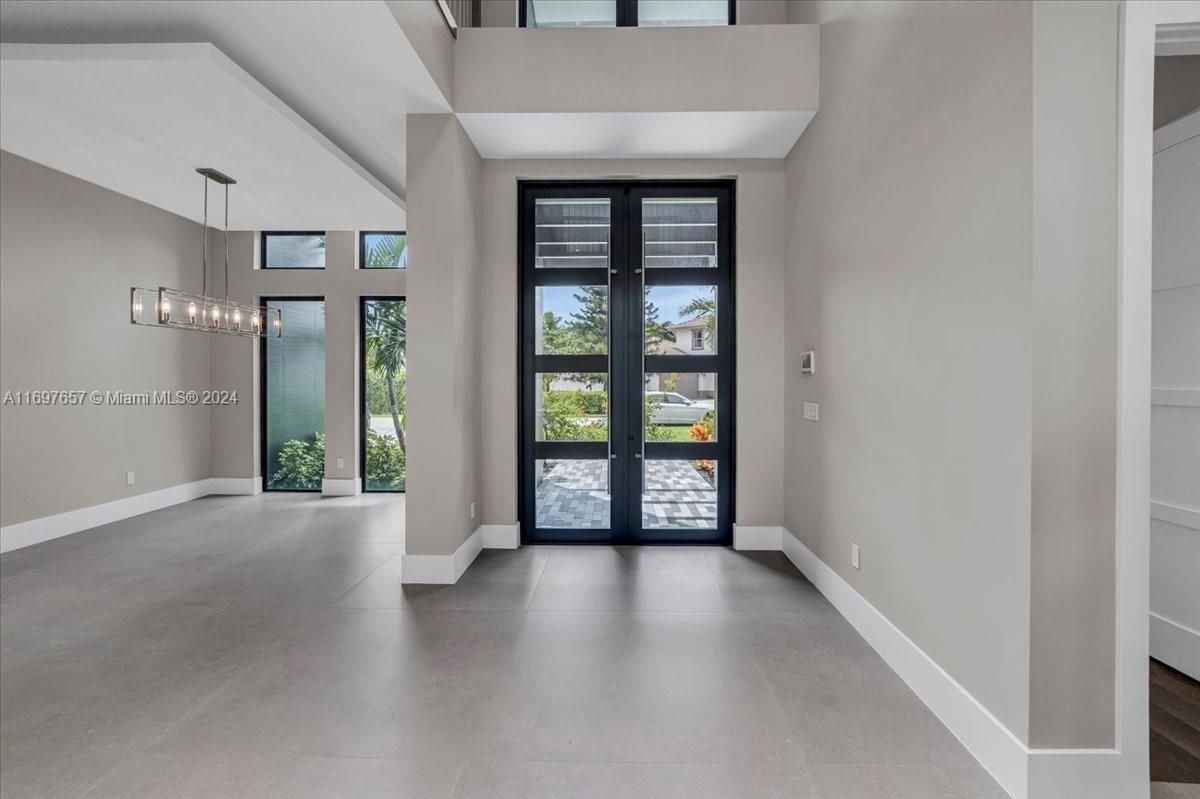 751 Northeast 2nd Street Boca Raton, FL 33432 - Photo 6 of 56 wooden floor in an empty room with a window