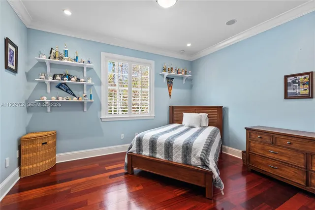 a bedroom with furniture and a baby crib
