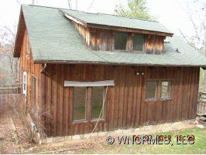 1448 Silvers Mill Road Marshall, NC 28753 - Photo 2 of 12 a front view of a house with a wooden fence