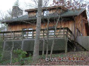 1448 Silvers Mill Road Marshall, NC 28753 - Photo 12 of 12 a view of a wooden house with a door and a bench