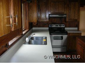 1448 Silvers Mill Road Marshall, NC 28753 - Photo 5 of 12 a kitchen with a stove and a refrigerator