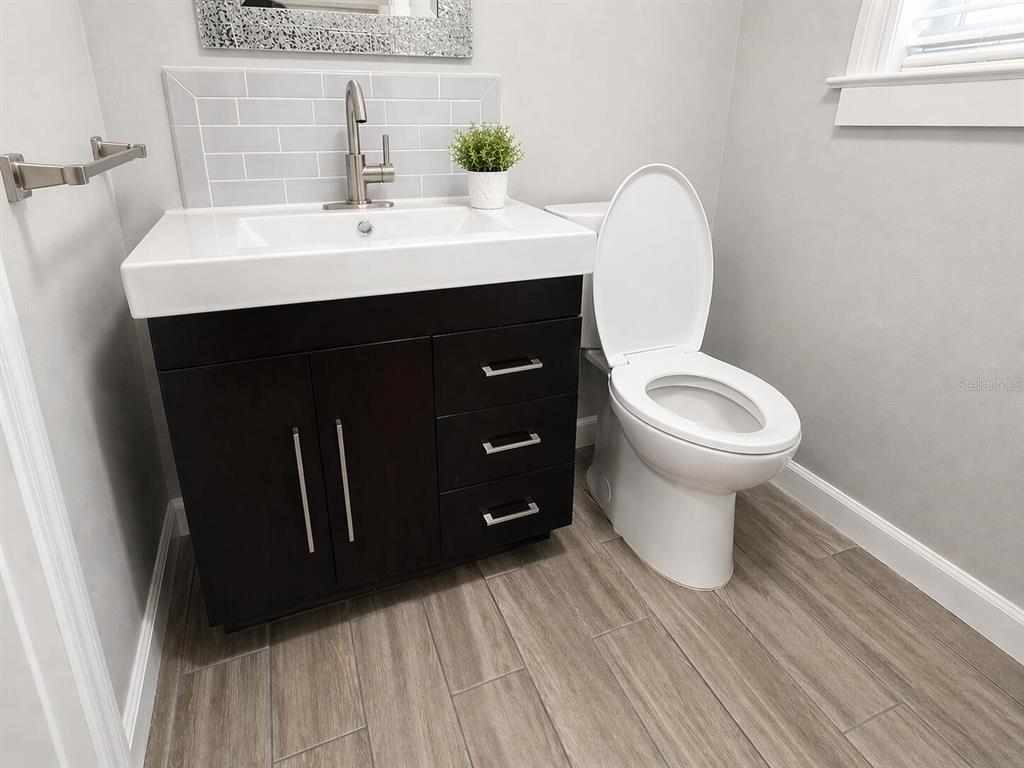 2313 Southeast 7th Street Ocala, FL 34471 - Photo 27 of 54 a bathroom with a sink and a mirror