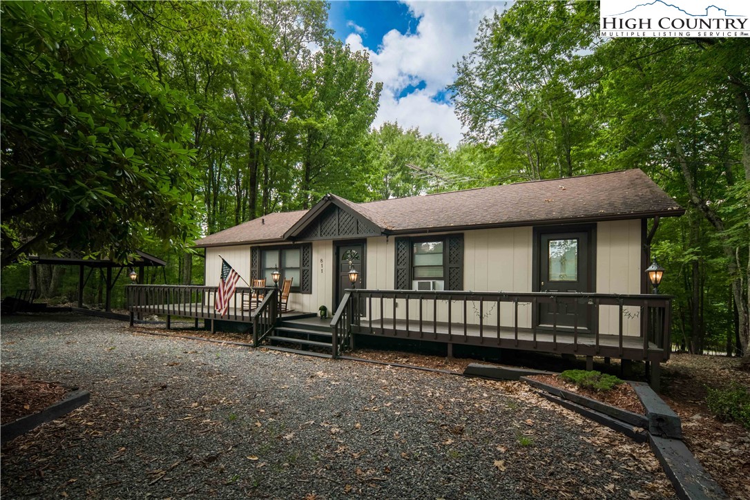 a view of a house with a yard and sitting area