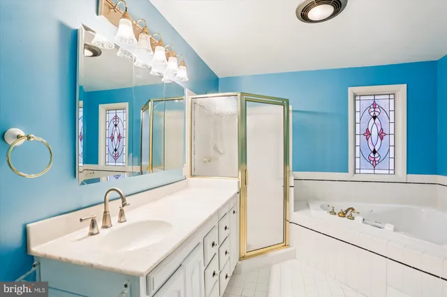a bathroom with a tub sink and mirror