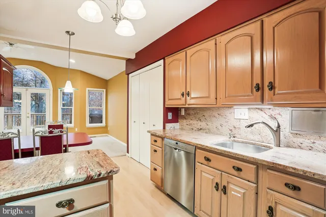 a kitchen with stainless steel appliances granite countertop a sink and cabinets