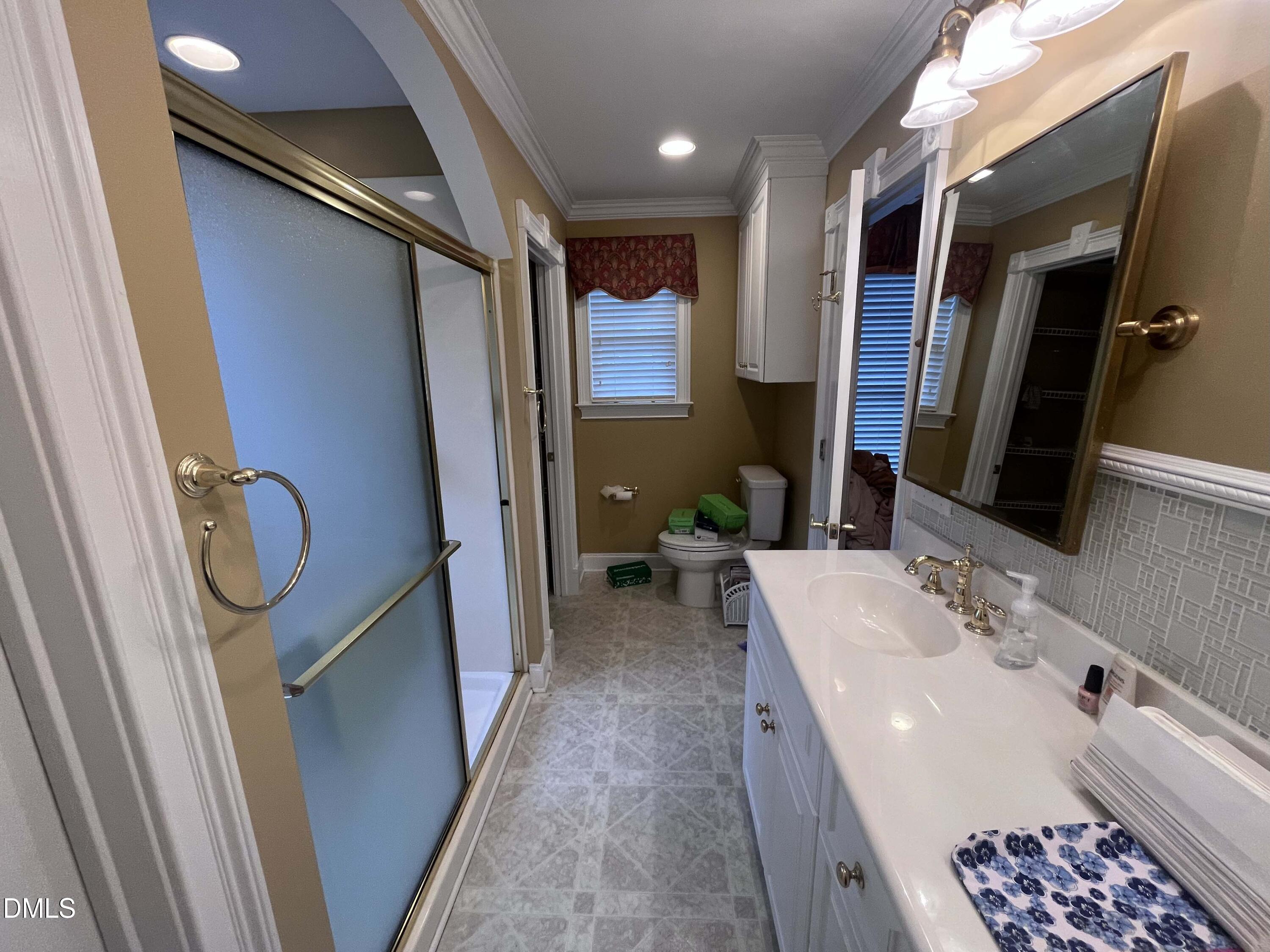 590 Hobson Road Dunn, NC 28334 - Photo 33 of 62 a bathroom with a sink a toilet and shower