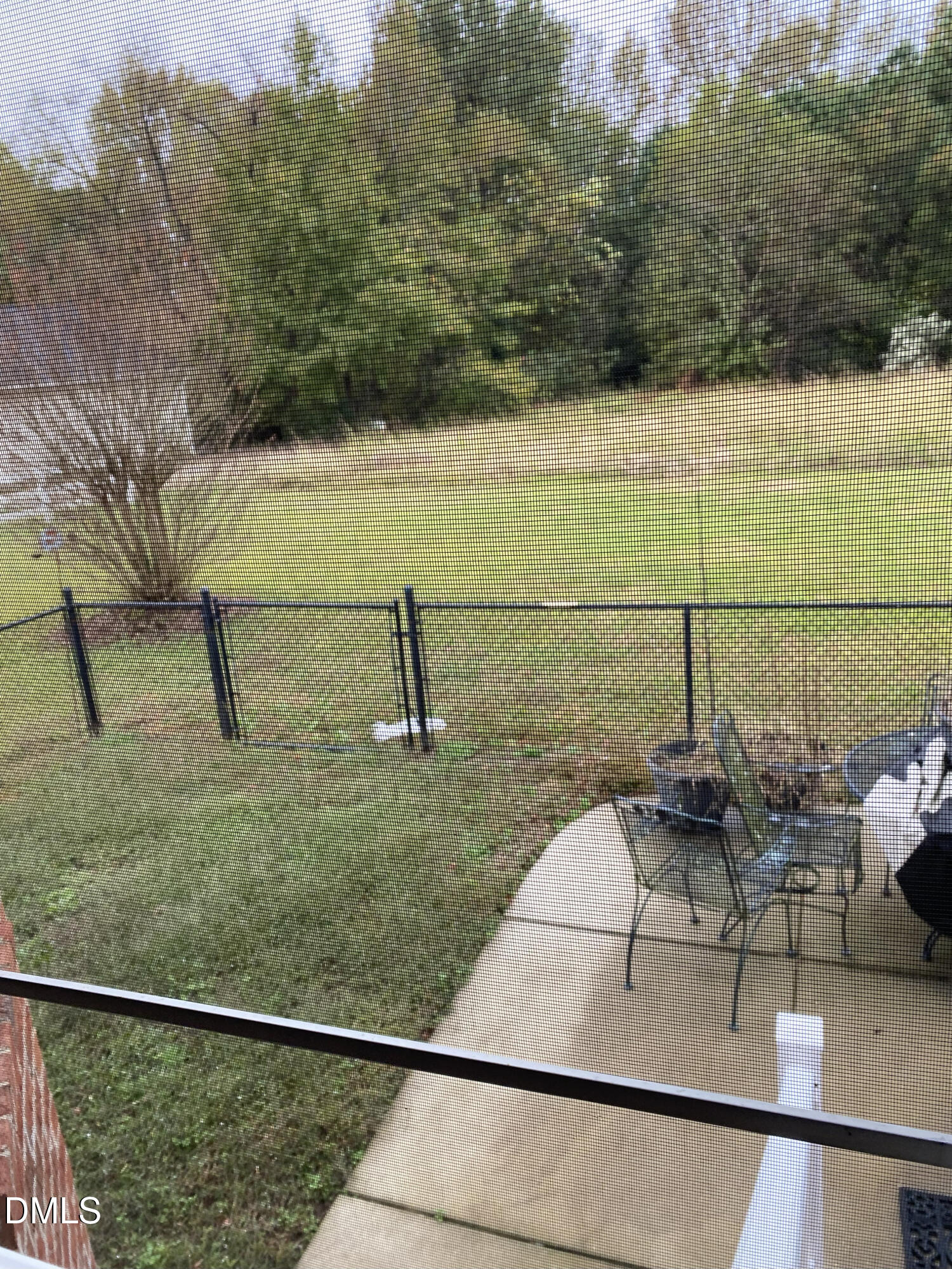 590 Hobson Road Dunn, NC 28334 - Photo 5 of 62 a view of a lake with a yard and a wooden fence