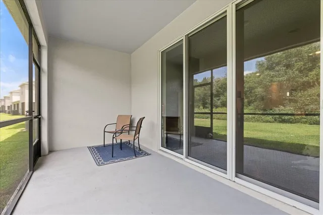 a view of an empty room and floor to ceiling window