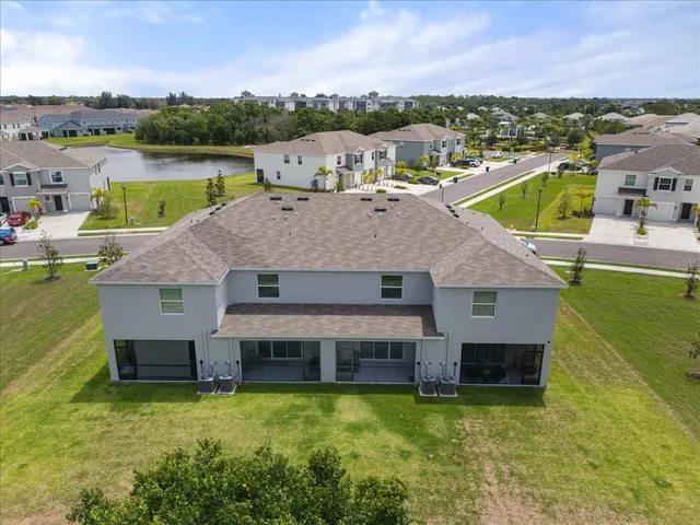 a aerial view of a house with a swimming pool and a big yard