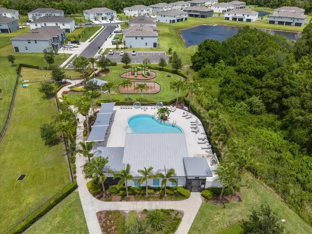an aerial view of residential house with outdoor space and swimming pool