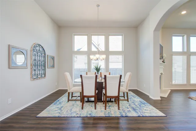 a kitchen with granite countertop a sink a stove and wooden cabinets