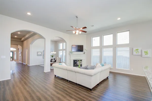 a living room with furniture a fireplace and a flat screen tv