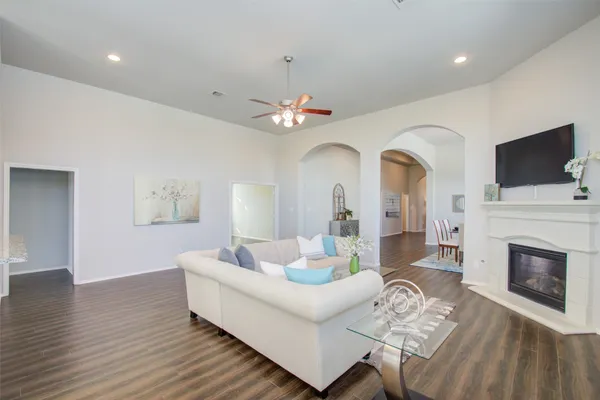 a living room with furniture a fireplace and a flat screen tv