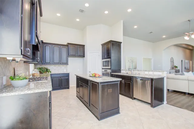 a bathroom with a granite countertop sink a mirror and vanity