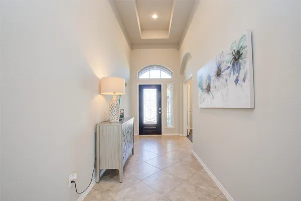 a view of a hallway with wooden floor and closet