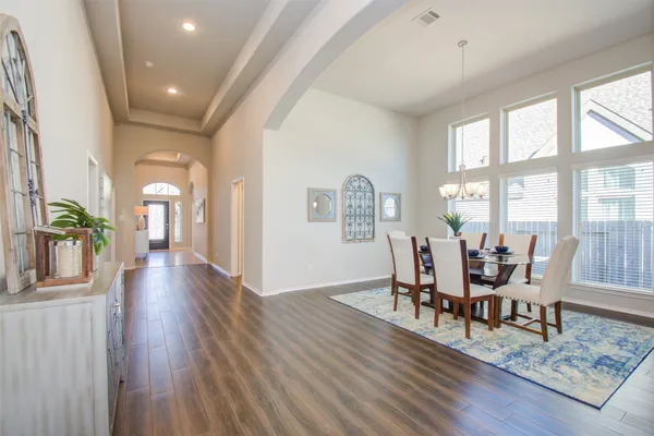 a view of a dining room with furniture and wooden floor